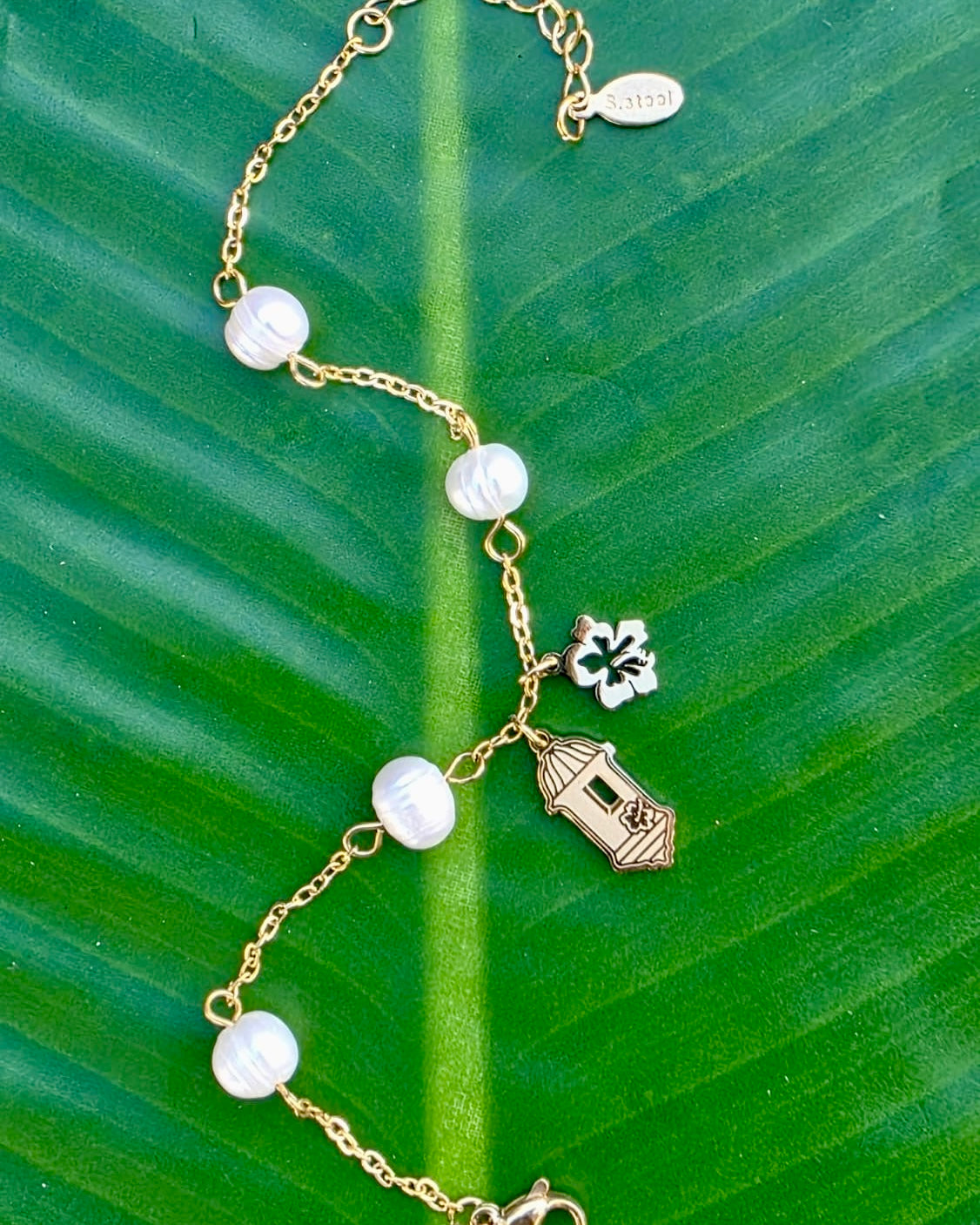 Gold stainless steel necklace pearl Garita del morro charm, and Flor de Maga flower, inspired by Puerto Rican culture.