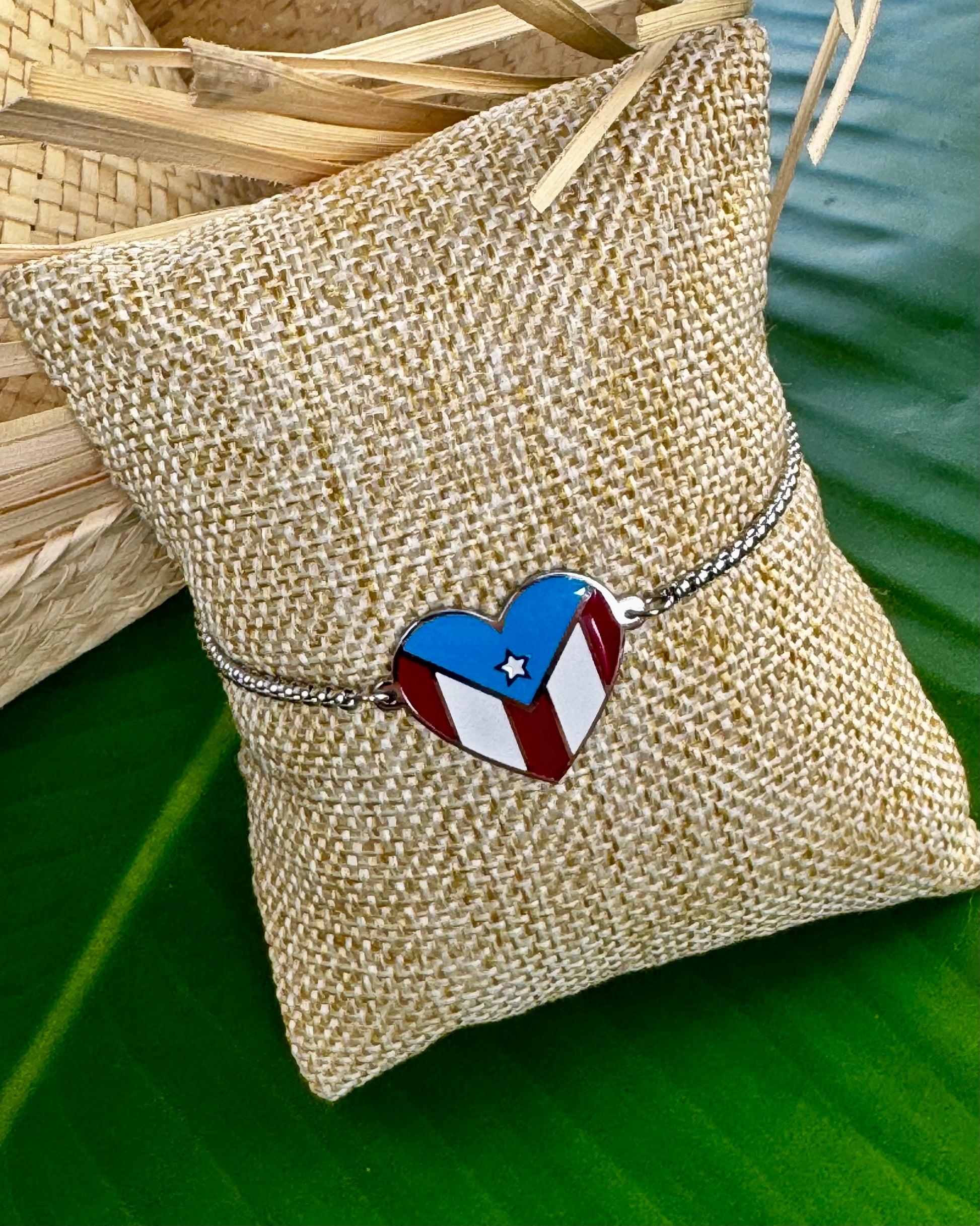Adjustable stainless steel bracelet with a heart-shaped charm displaying the Puerto Rico flag, representing cultural pride, love, and connection to Puerto Rico.