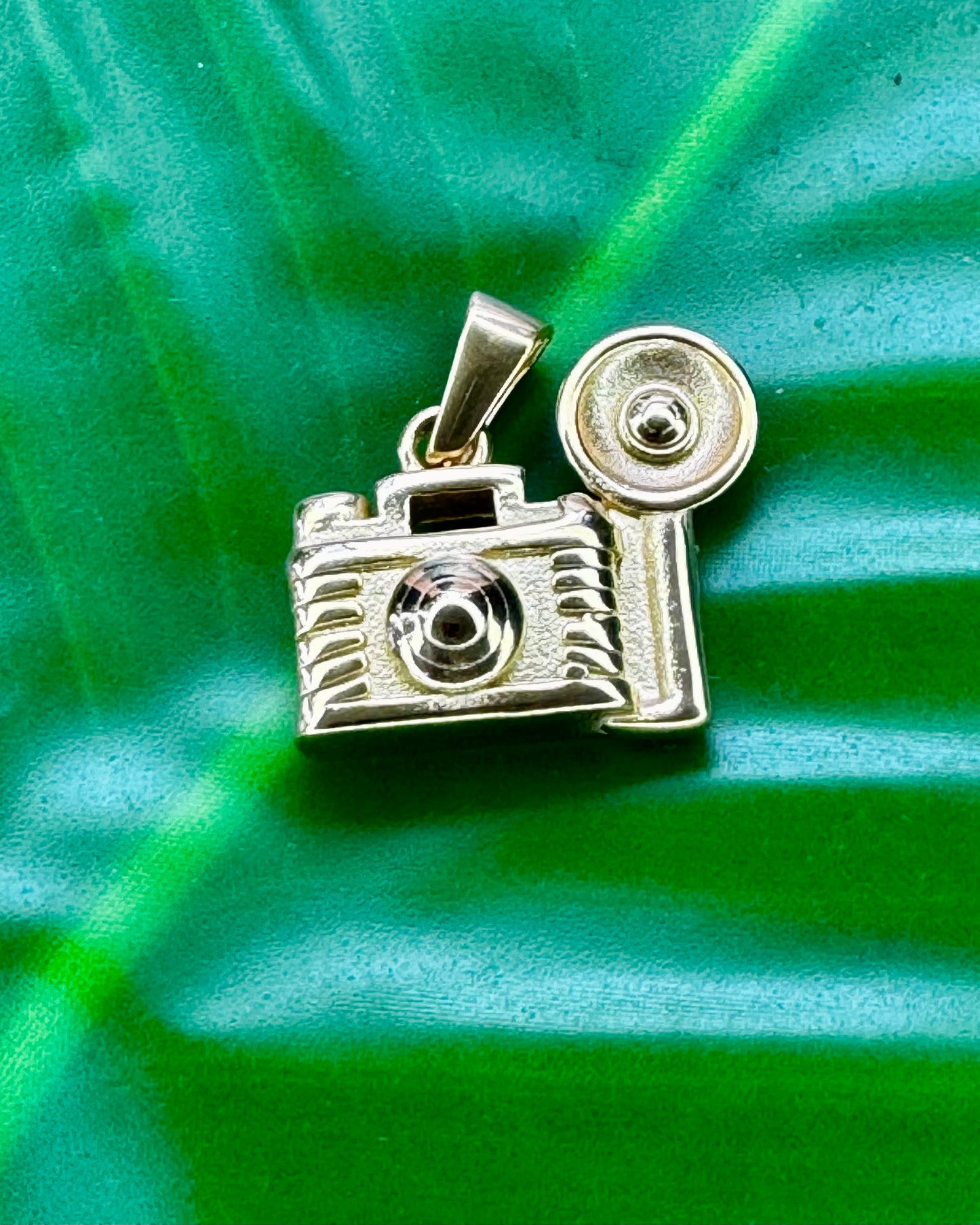 Camera charm in gold stainless steel referencing Bad Bunny’s song about taking more pictures