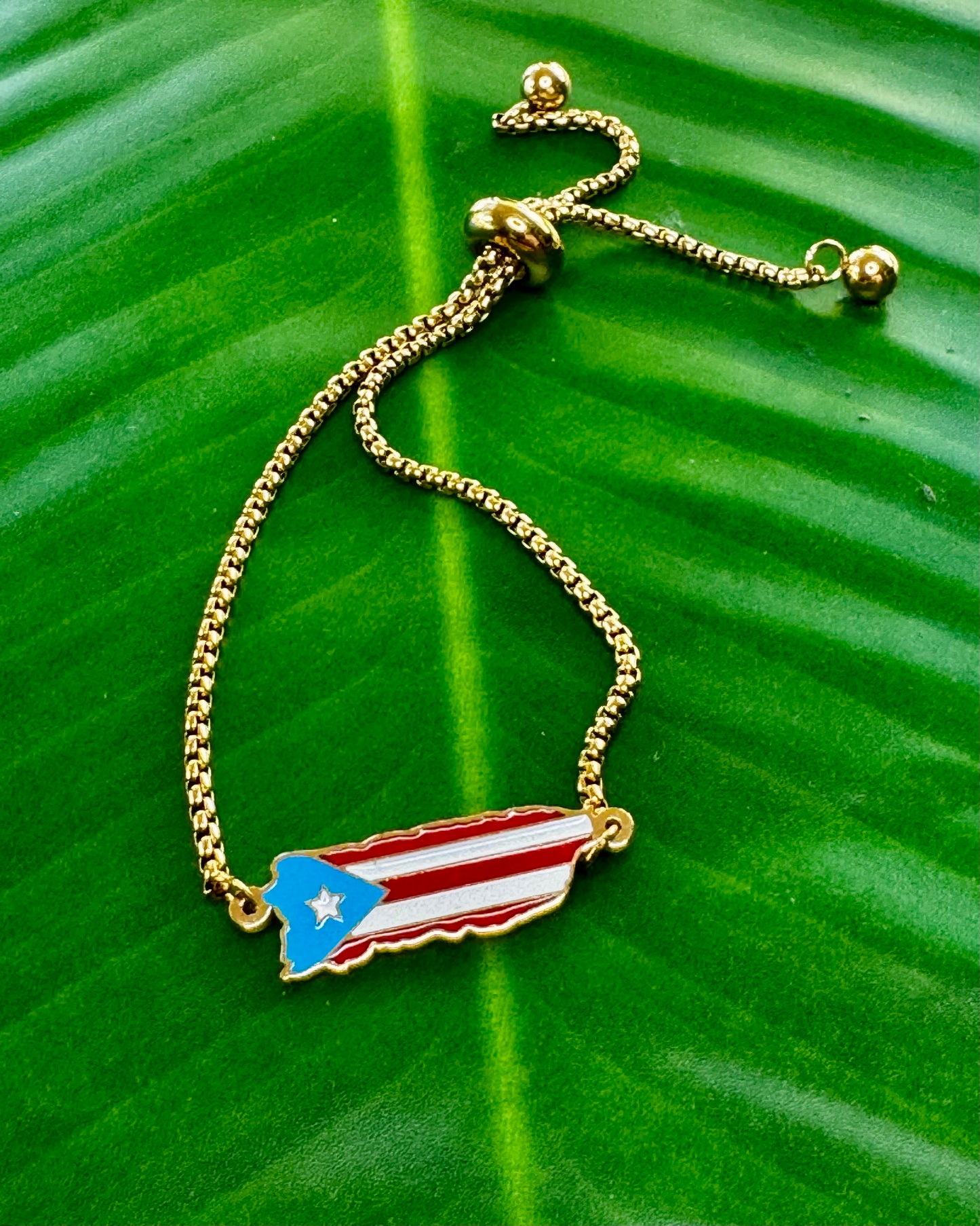 Adjustable stainless steel bracelet in silver or gold with Puerto Rico island charm decorated in Puerto Rican flag colors