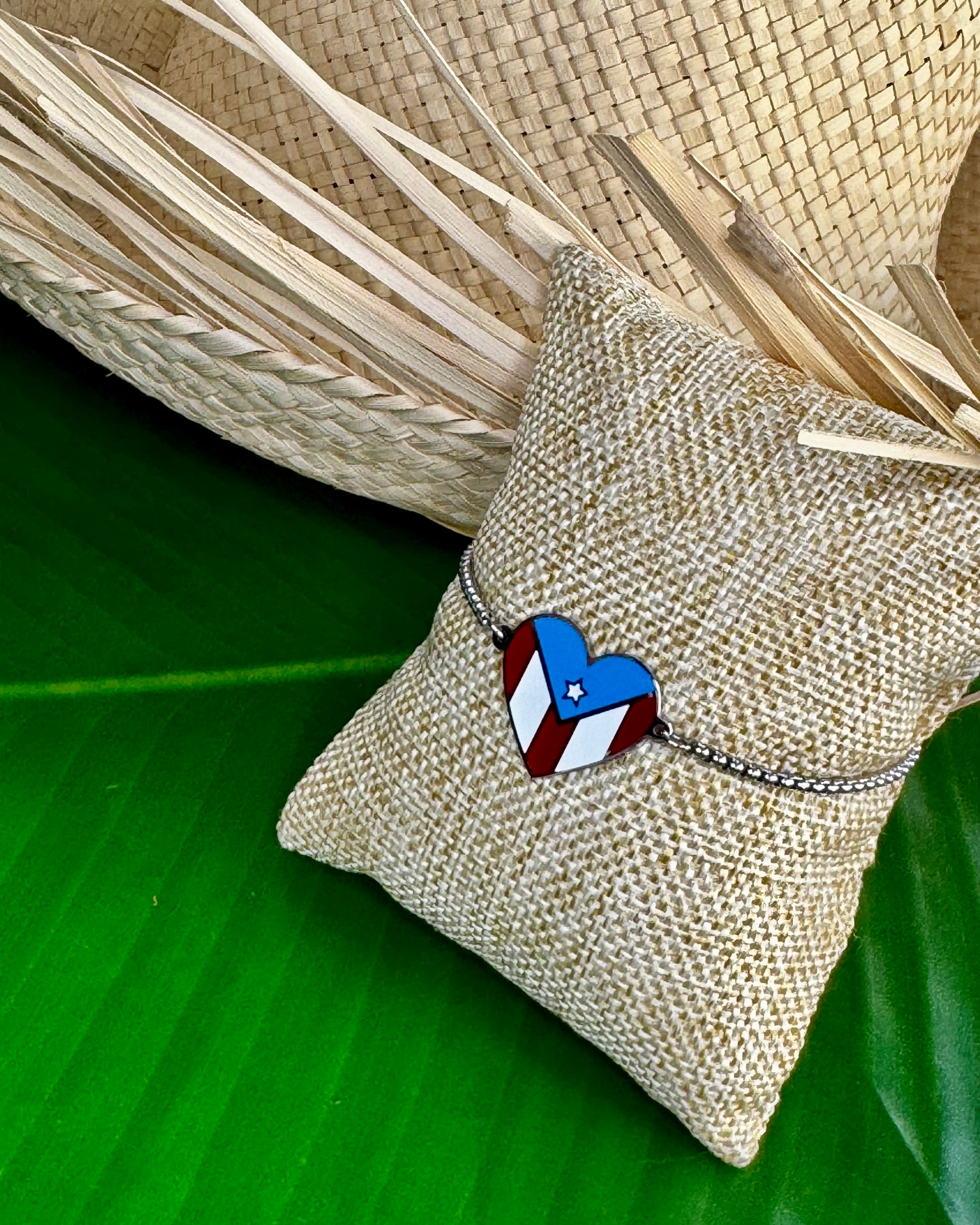 Adjustable stainless steel bracelet with a heart-shaped charm displaying the Puerto Rico flag, representing cultural pride, love, and connection to Puerto Rico.