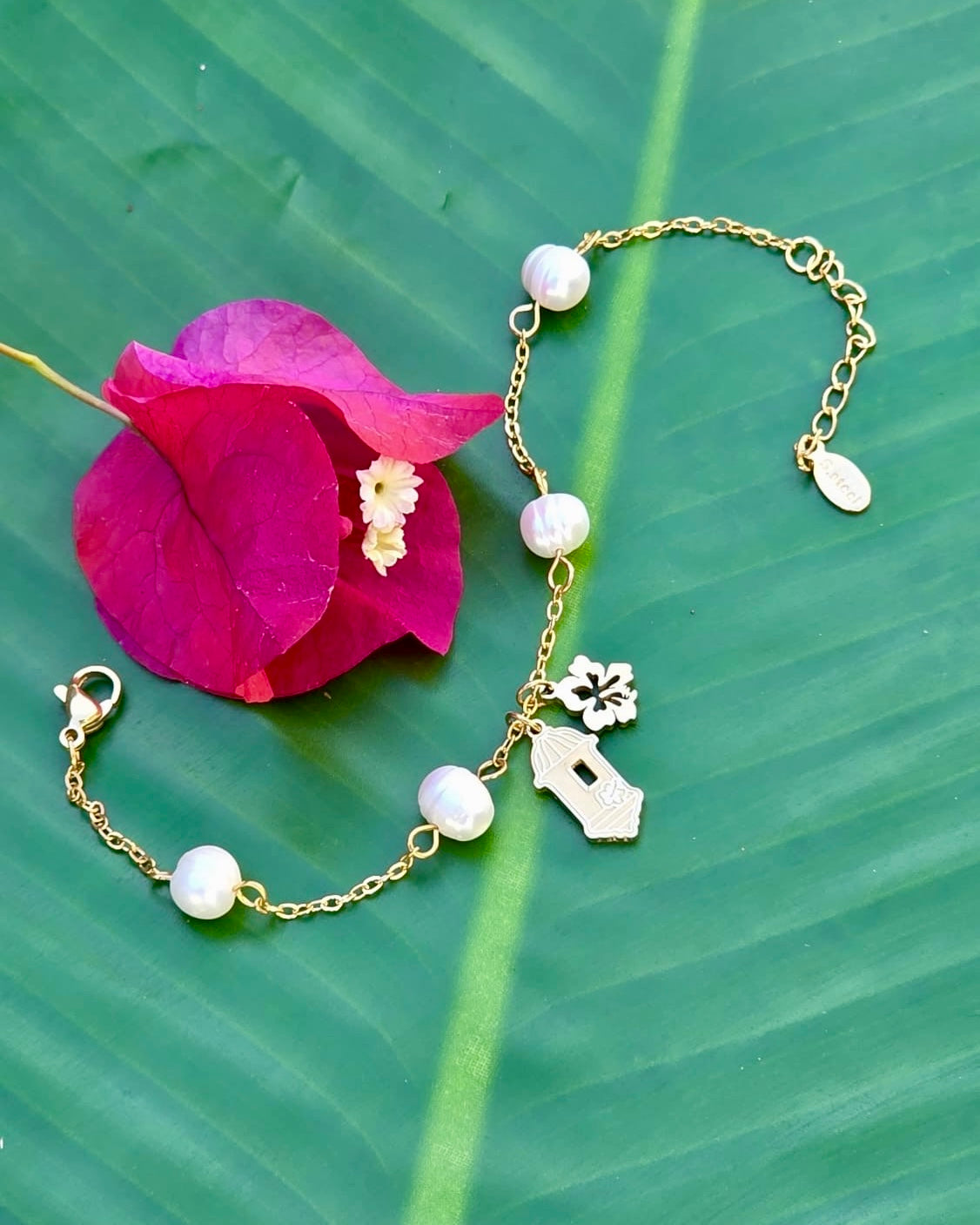 Gold stainless steel bracelet pearl Garita del morro charm, and Flor de Maga flower, inspired by Puerto Rican culture.