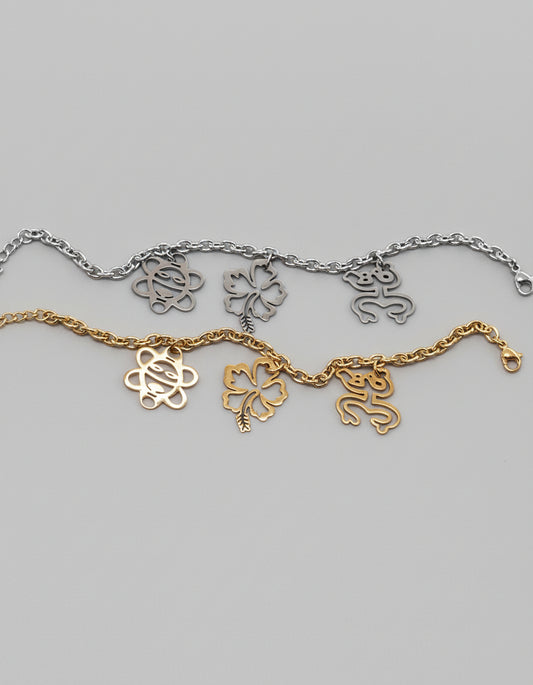 Stainless steel bracelet with Coquí Taíno, Flor de Maga, and Sol Taíno charms in gold or silver.