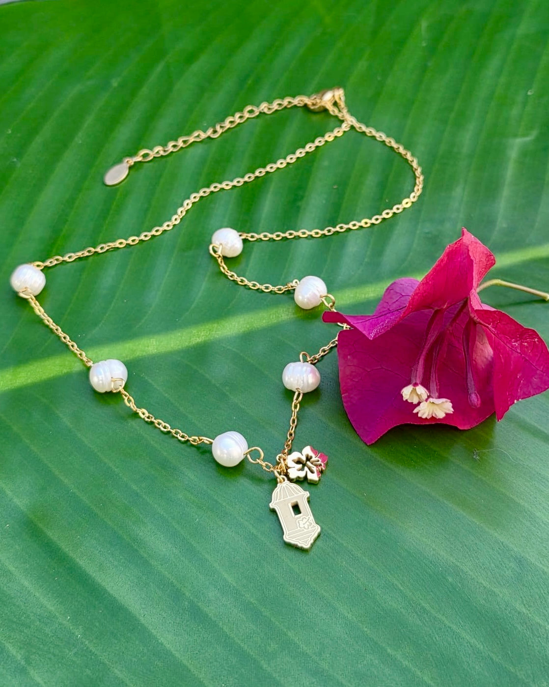 Gold stainless steel necklace pearl Garita del morro charm, and Flor de Maga flower, inspired by Puerto Rican culture.