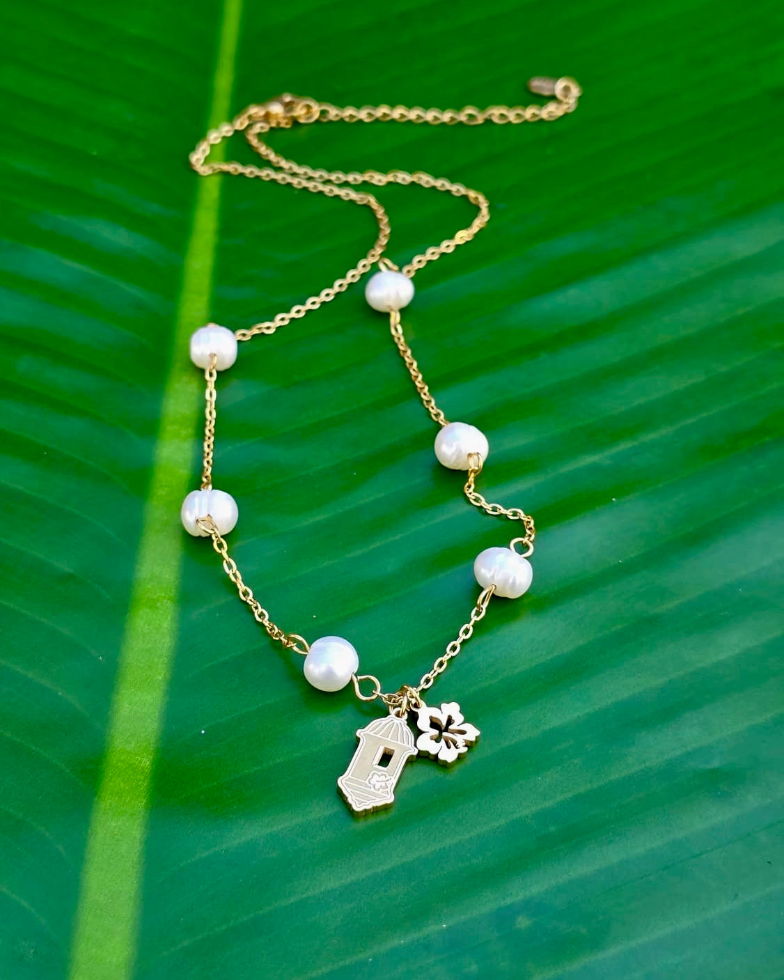 Gold stainless steel necklace pearl Garita del morro charm, and Flor de Maga flower, inspired by Puerto Rican culture.