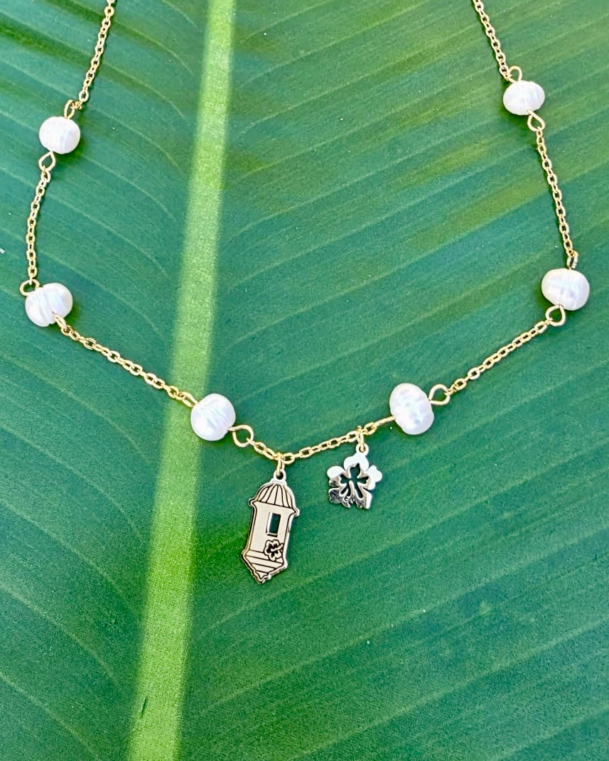 Gold stainless steel necklace pearl Garita del morro charm, and Flor de Maga flower, inspired by Puerto Rican culture.