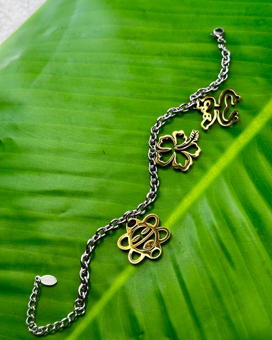 Puerto Rican jewelry bracelet featuring Maga flower, Coquí frog, and Sol Taíno charms in two-tone stainless steel.