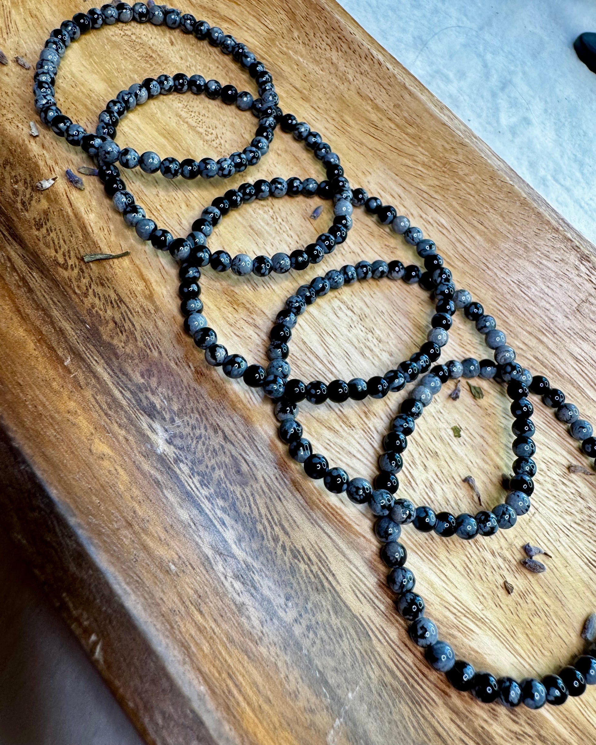 4mm Snowflake Obsidian bracelet with small black beads featuring natural gray snowflake patterns.