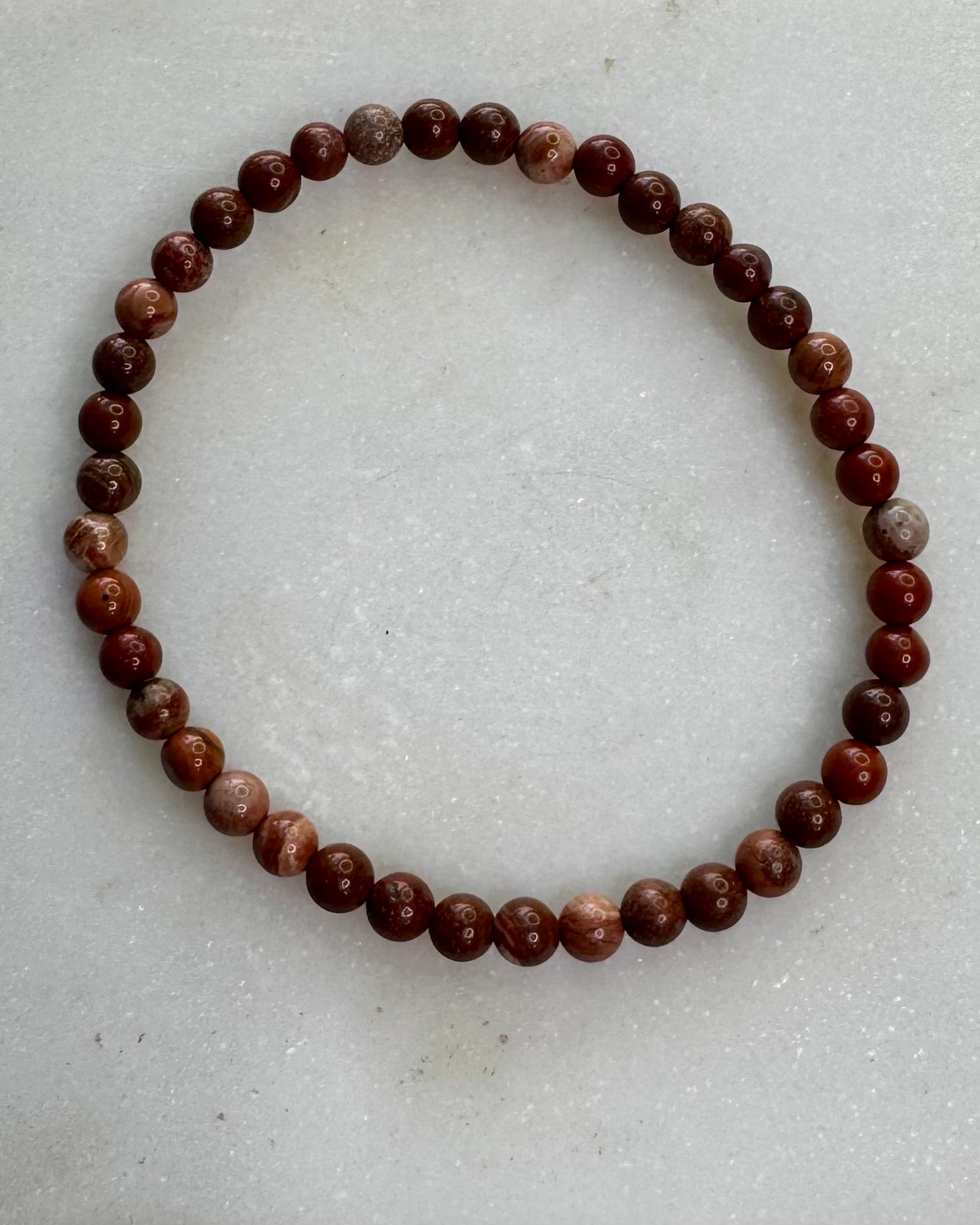 4mm Brecciated Jasper crystal bracelet with rich red and brown patterns, a stone for protection and motivation.