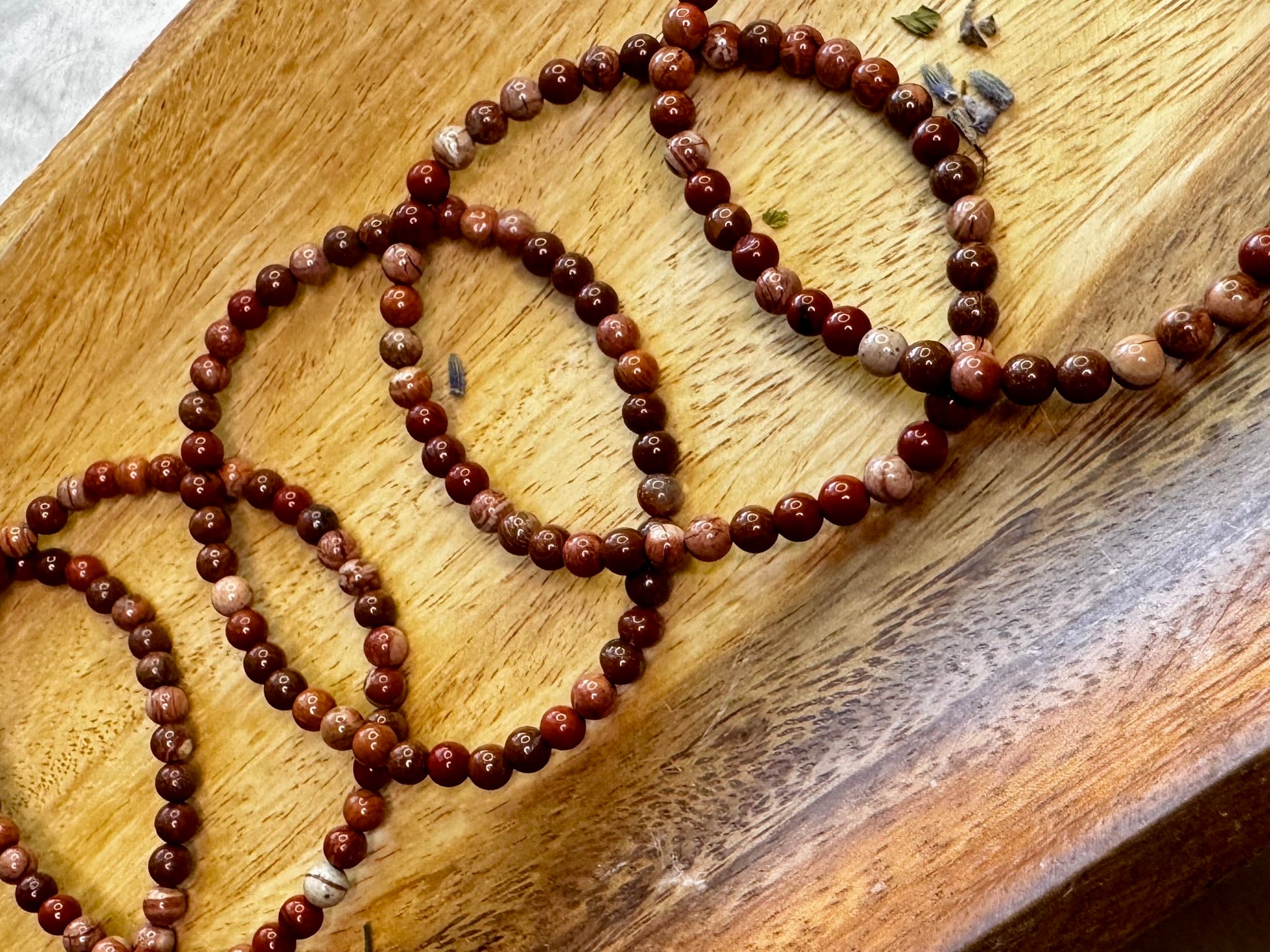 4mm Brecciated Jasper crystal bracelet with rich red and brown patterns, a stone for protection and motivation.