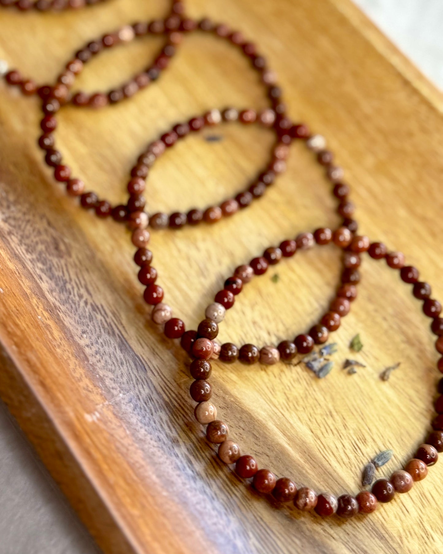 4mm Brecciated Jasper crystal bracelet with rich red and brown patterns, a stone for protection and motivation.