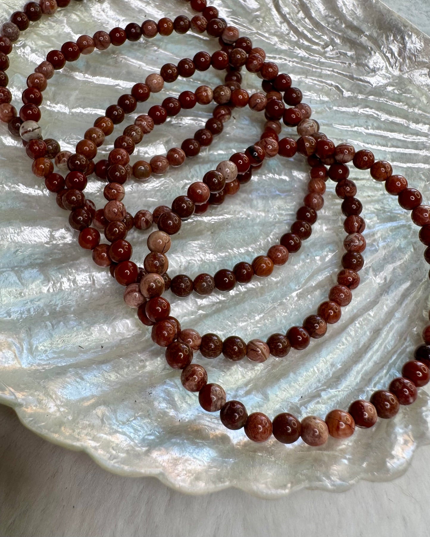 4mm Brecciated Jasper crystal bracelet with rich red and brown patterns, a stone for protection and motivation.