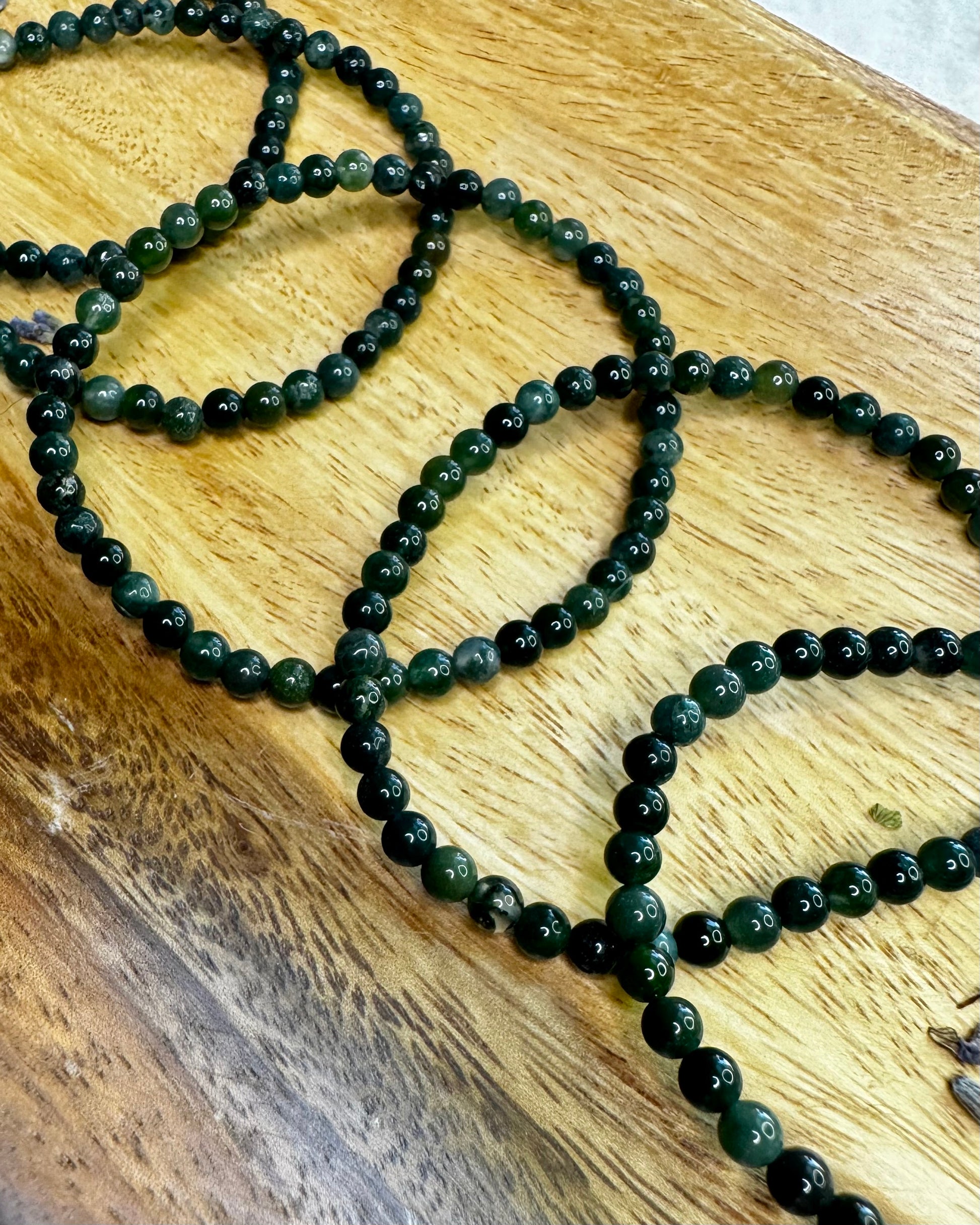4mm Moss Agate bracelet with natural green gemstone beads, known for grounding and heart-healing energy.