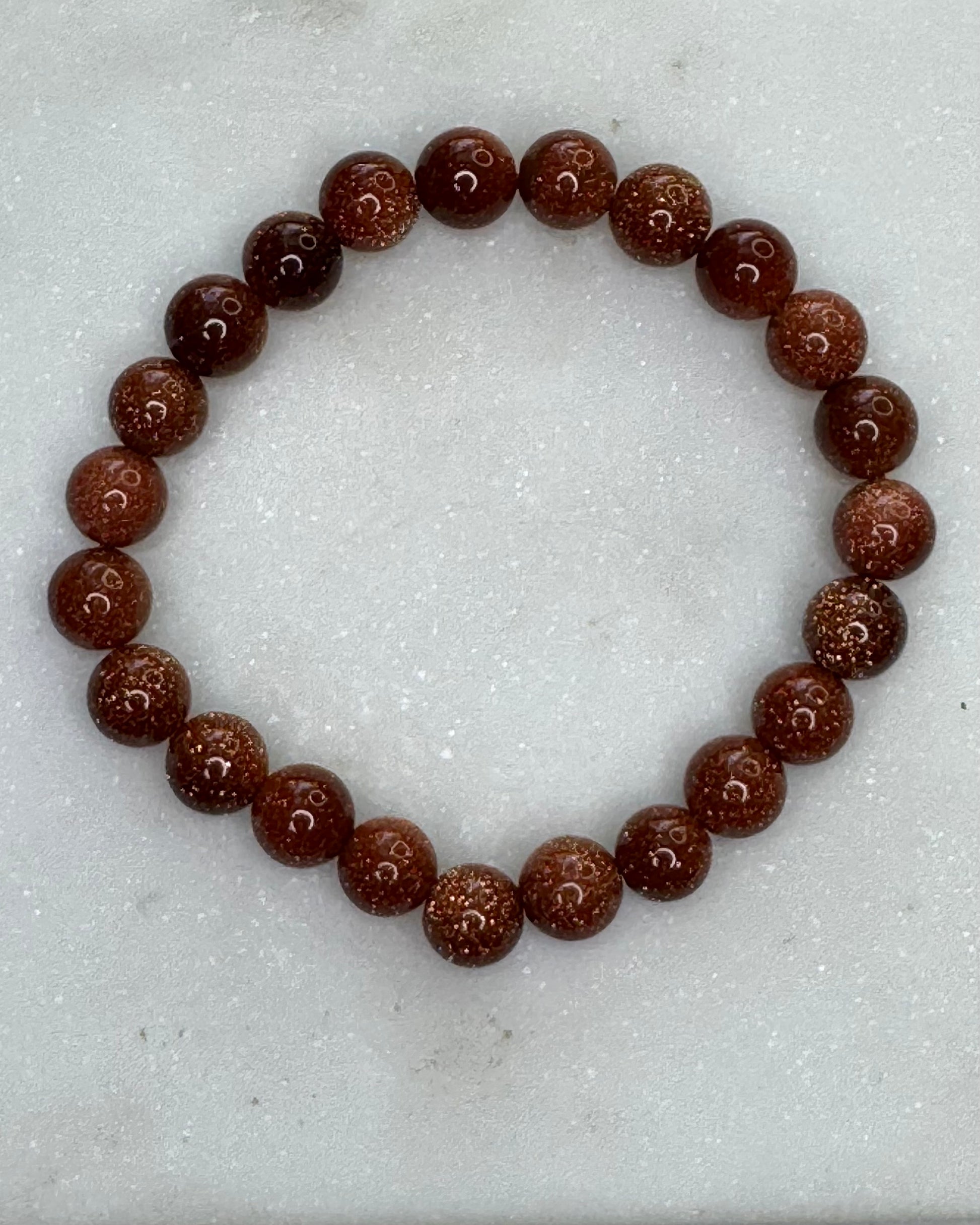 8mm gold sandstone energy bracelet with glittering gold beads for confidence and positivity.