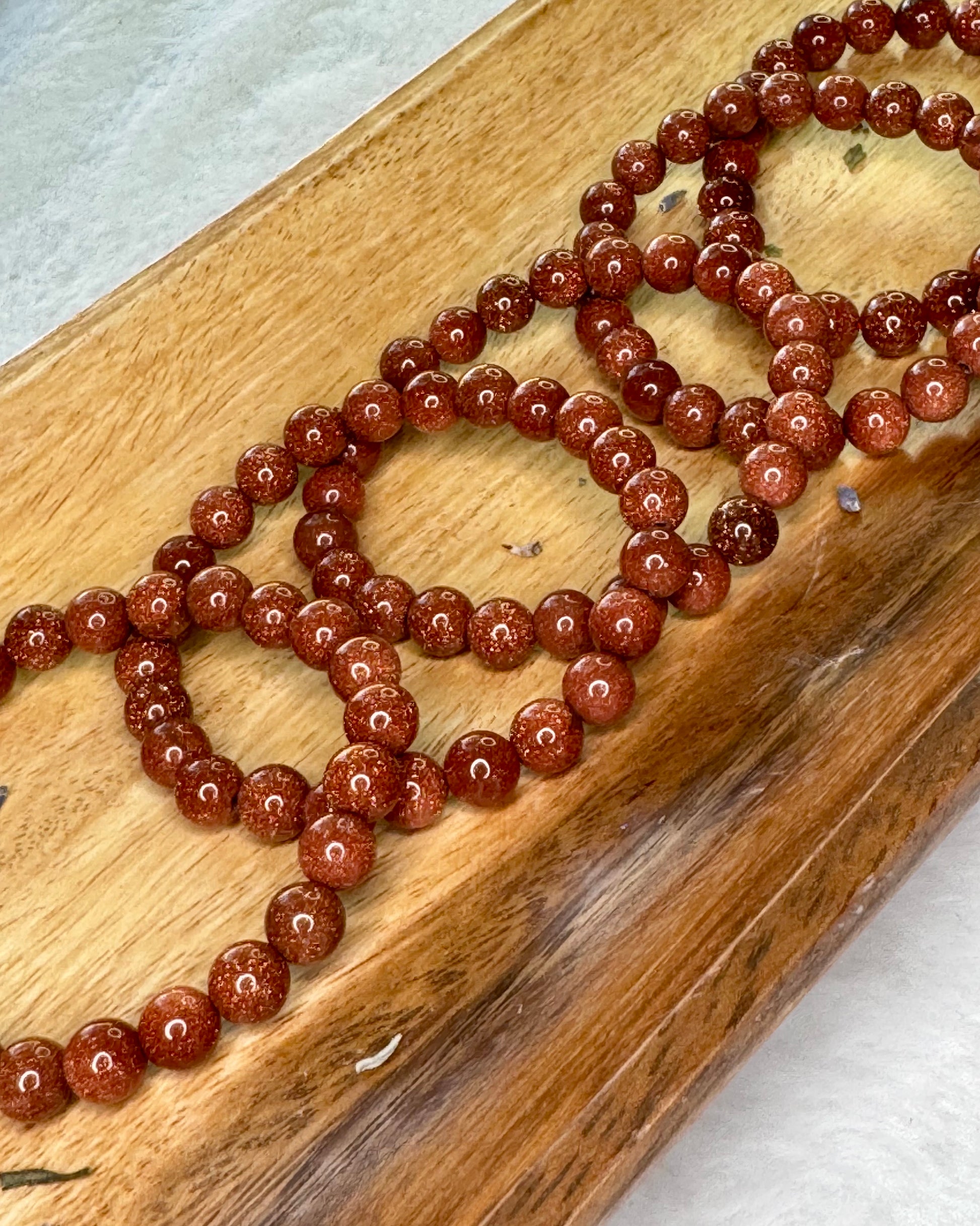 8mm gold sandstone energy bracelet with glittering gold beads for confidence and positivity.
