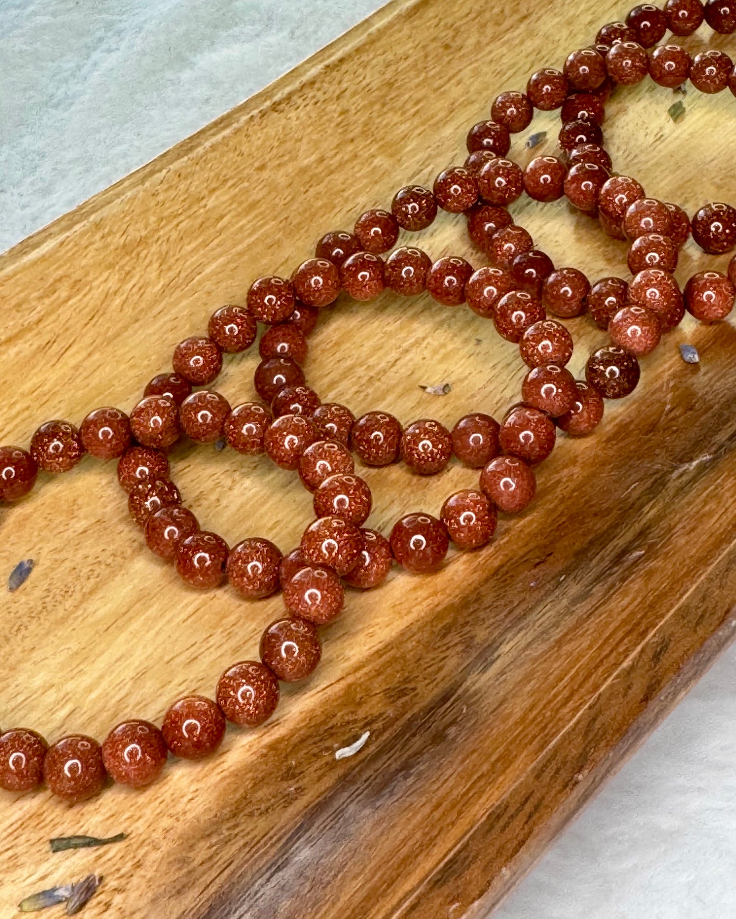 8mm gold sandstone energy bracelet with glittering gold beads for confidence and positivity.