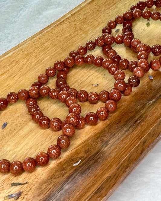 8mm gold sandstone energy bracelet with glittering gold beads for confidence and positivity.